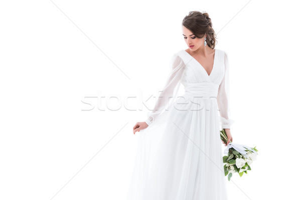 Atraente noiva posando vestido branco buquê de casamento isolado Foto stock © LightFieldStudios