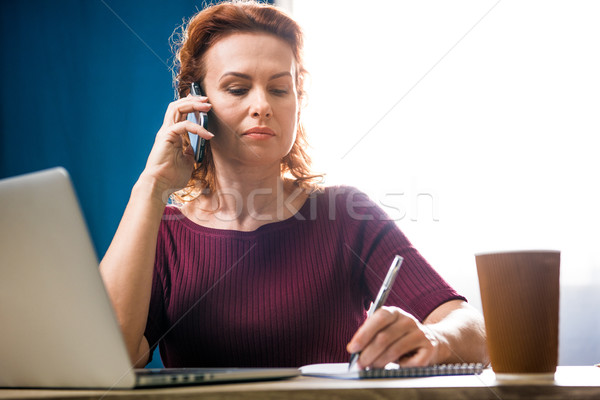 Woman talking on smartphone Stock photo © LightFieldStudios