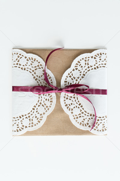 top view of envelope with lace and ribbon isolated on white, invitation card wedding concept Stock photo © LightFieldStudios