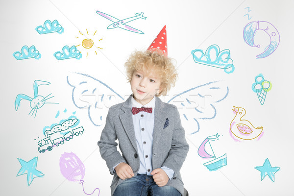 curly boy in cone hat  Stock photo © LightFieldStudios