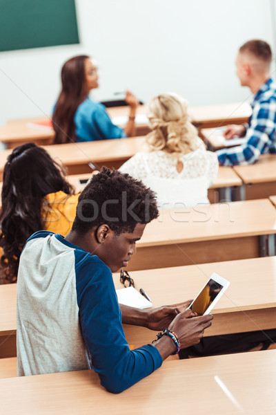 student using tablet on lecture Stock photo © LightFieldStudios
