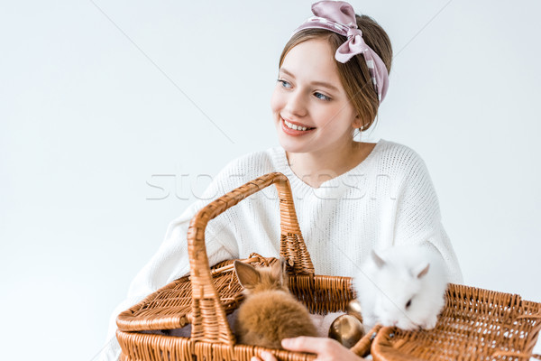 adorable happy girl holding basket with cute furry rabbits isolated on white Stock photo © LightFieldStudios
