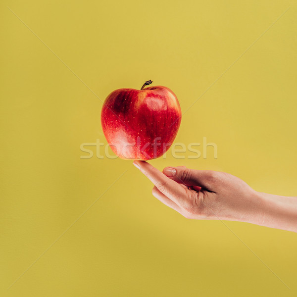 partial view of woman holding apple on finger Stock photo © LightFieldStudios