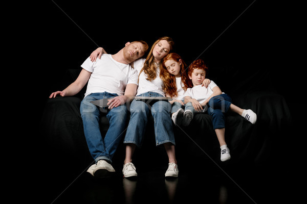 sleeping family with various digital devices isolated on black Stock photo © LightFieldStudios
