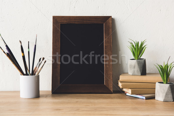 photo frame and book on tabletop Stock photo © LightFieldStudios