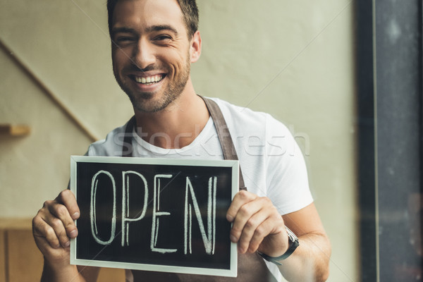 waiter holding chalkboard with open word Stock photo © LightFieldStudios