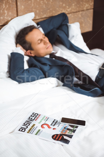 Business newspaper on hotel bed Stock photo © LightFieldStudios