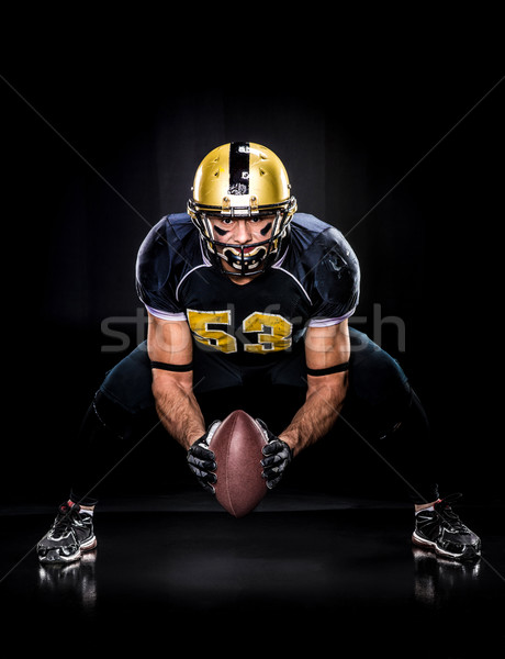 Stock photo: American football player holding ball 