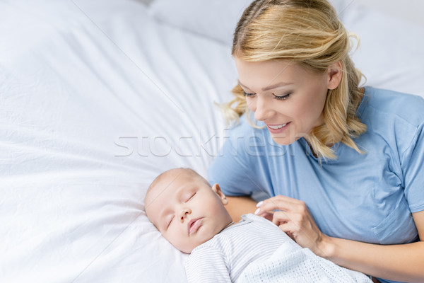 mother looking at sleeping baby Stock photo © LightFieldStudios
