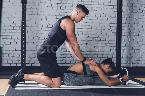 trainer helping woman to stretch Stock photo © LightFieldStudios