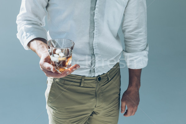 Stock photo: man holding whiskey with ice