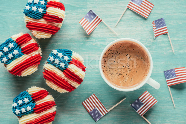 flat lay with arranged cupcakes, cup of coffee and american flags on wooden tabletop, presidents day Stock photo © LightFieldStudios