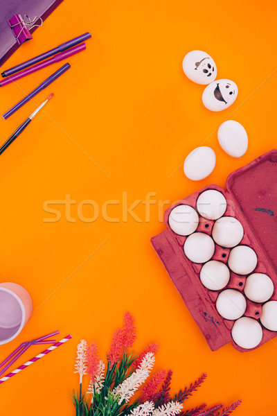 top view of chicken eggs in egg tray and felt tip pens for easter painting isolated on orange Stock photo © LightFieldStudios