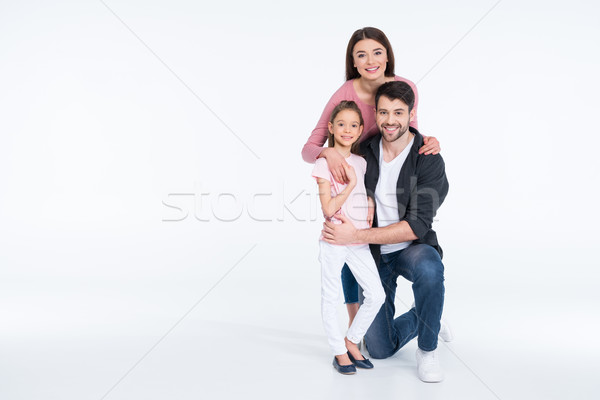 Happy young family with one child hugging on white Stock photo © LightFieldStudios