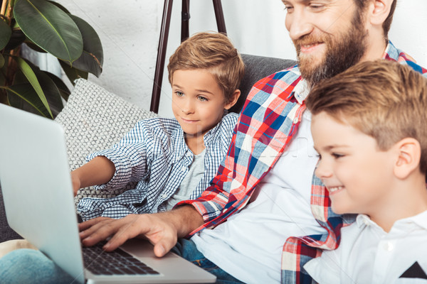 father with sons using laptop Stock photo © LightFieldStudios