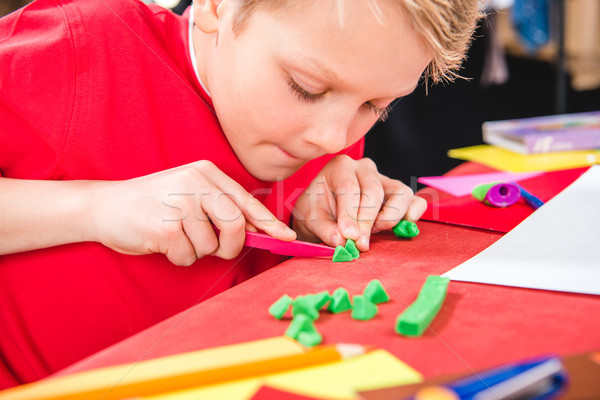 Schoolchild cutting plasticine Stock photo © LightFieldStudios