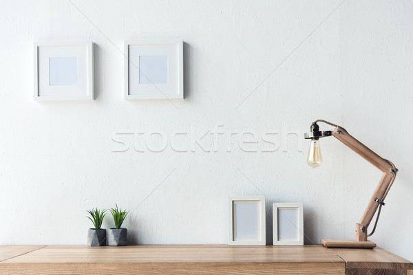 Stock photo: photo frames hanging on wall at workplace