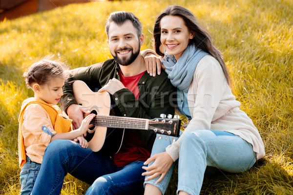 Family sitting in autumn park Stock photo © LightFieldStudios