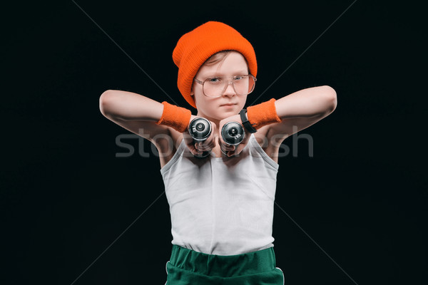 Stock photo: boy training with dumbbells isolated on black. athletics children concept