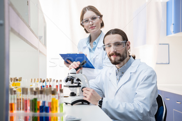 Travail microscope deux souriant prendre des notes laboratoire [[stock_photo]] © LightFieldStudios