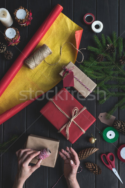 woman decorating christmas gifts Stock photo © LightFieldStudios