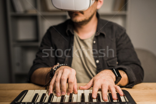 man in vr goggles using MPC pad Stock photo © LightFieldStudios