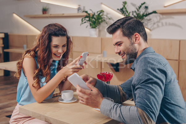 Stock photo: couple with smartphones in cafe