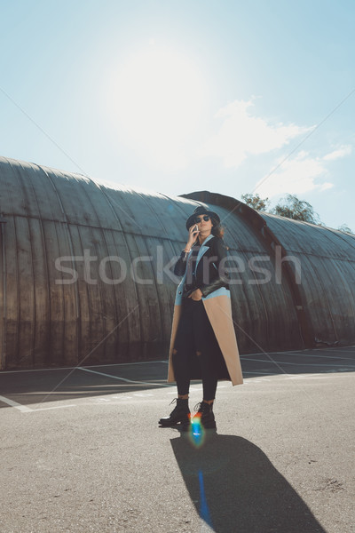  Woman in autumn outfit talking by smartphone Stock photo © LightFieldStudios
