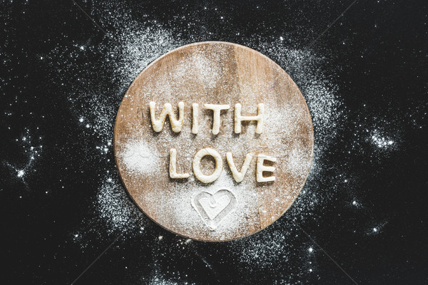 Top view of edible lettering with love from dough on wooden cutting board, baking cookies concept Stock photo © LightFieldStudios