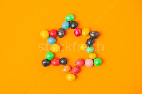 top view of star made of sweets isolated on orange, purim holiday concept Stock photo © LightFieldStudios