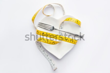 measuring tape wrapped around plate isolated on white, healthy living concept Stock photo © LightFieldStudios