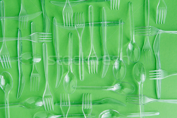 top view of set of various plastic cutlery isolated on green Stock photo © LightFieldStudios