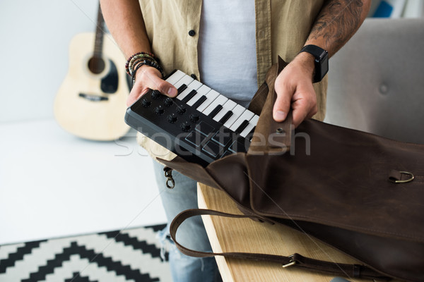 Stock photo: musician putting MPC pad into bag