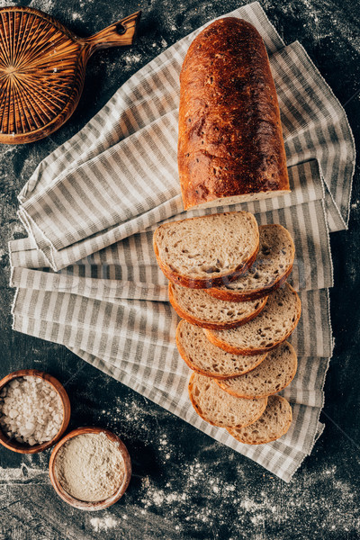 Stock photo: flat lay with pieces of bread on linen and bowls with flour near by on dark tabletop