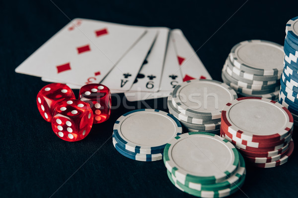 Dice with playing cards and chips on casino table Stock photo © LightFieldStudios