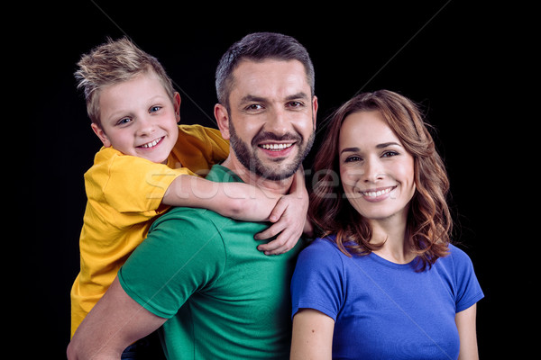 Happy family smiling at camera Stock photo © LightFieldStudios
