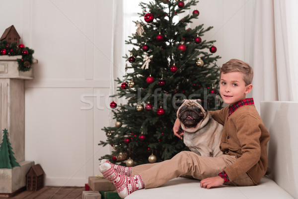 Boy Sitting On Couch With Pug Stock Photo C Lightfield Studios