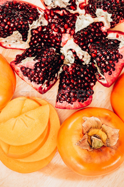 top view of persimmons and pomegranates on plate Stock photo © LightFieldStudios