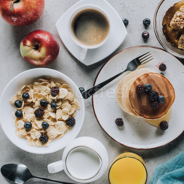 Stock photo: top view of tasty healthy breakfast with pancakes, fruits and muesli on grey 