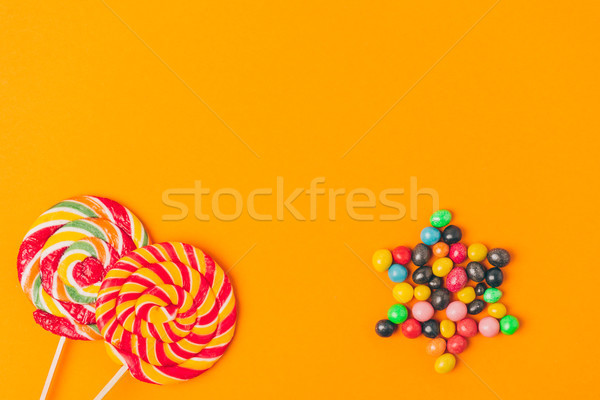 top view of lollipops and star made of candies isolated on orange, purim holiday concept Stock photo © LightFieldStudios