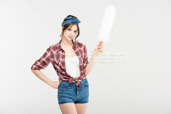 Young woman with duster Stock photo © LightFieldStudios