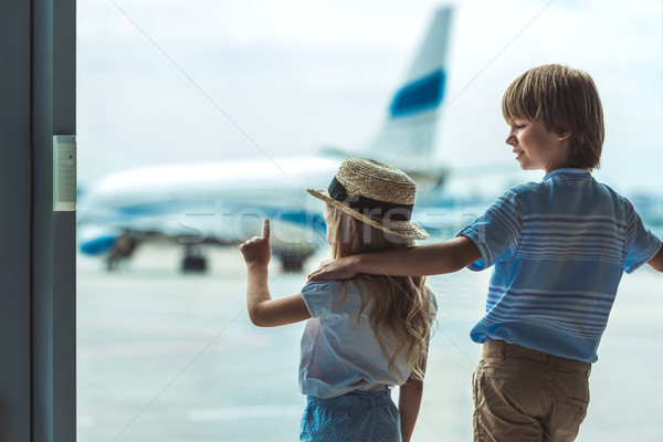 kids looking out window in airport Stock photo © LightFieldStudios