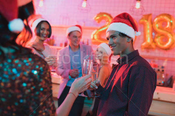 multiethnic friends clinking glasses of champagne Stock photo © LightFieldStudios