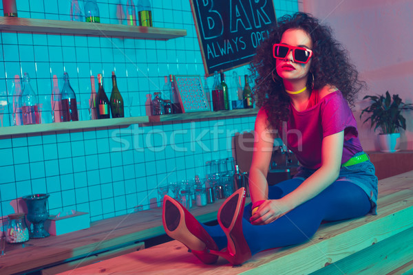 stylish woman sitting on counter Stock photo © LightFieldStudios