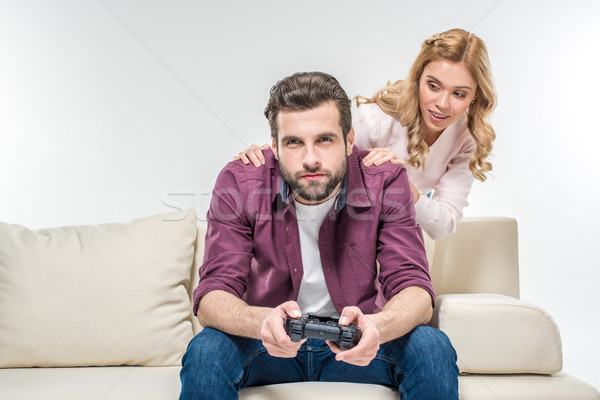 Mulher olhando homem jogar joystick mulher loira Foto stock © LightFieldStudios