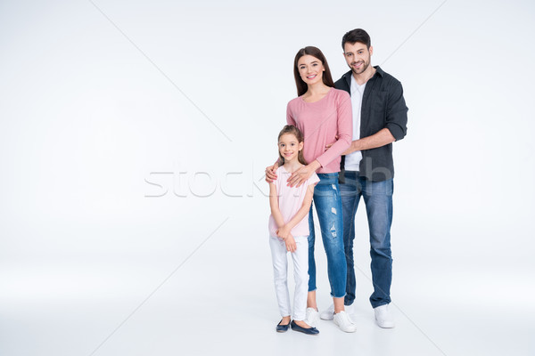 Happy young family with one child standing together and smiling at camera Stock photo © LightFieldStudios