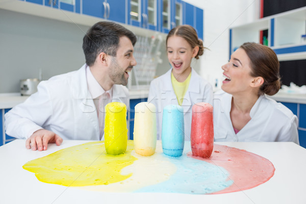 portrait of cheerful teachers and girl student scientists making experiment in lab Stock photo © LightFieldStudios