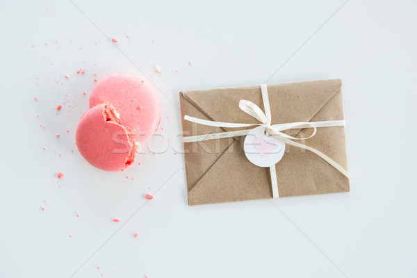 Top view of decorative kraft envelope with bow and pink macarons isolated on white, wedding invitati Stock photo © LightFieldStudios
