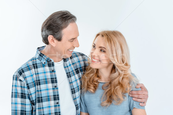 Front view of man and blonde woman embracing and smiling on white Stock photo © LightFieldStudios