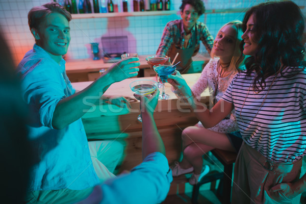 friends with drinks in bar Stock photo © LightFieldStudios